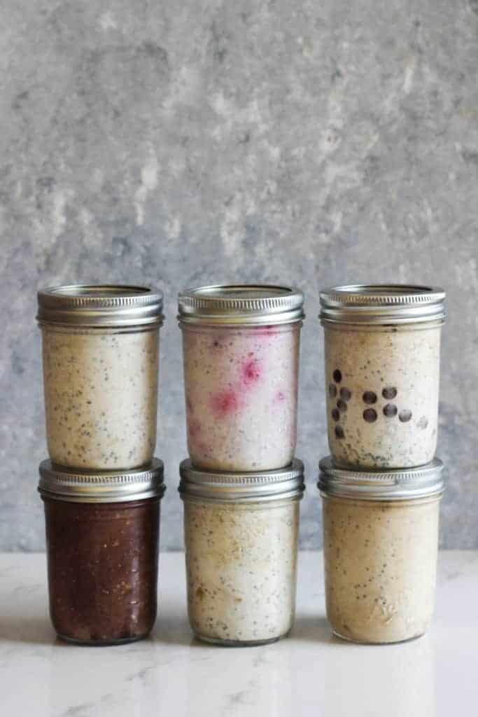 6 jars of overnight oats on a white background