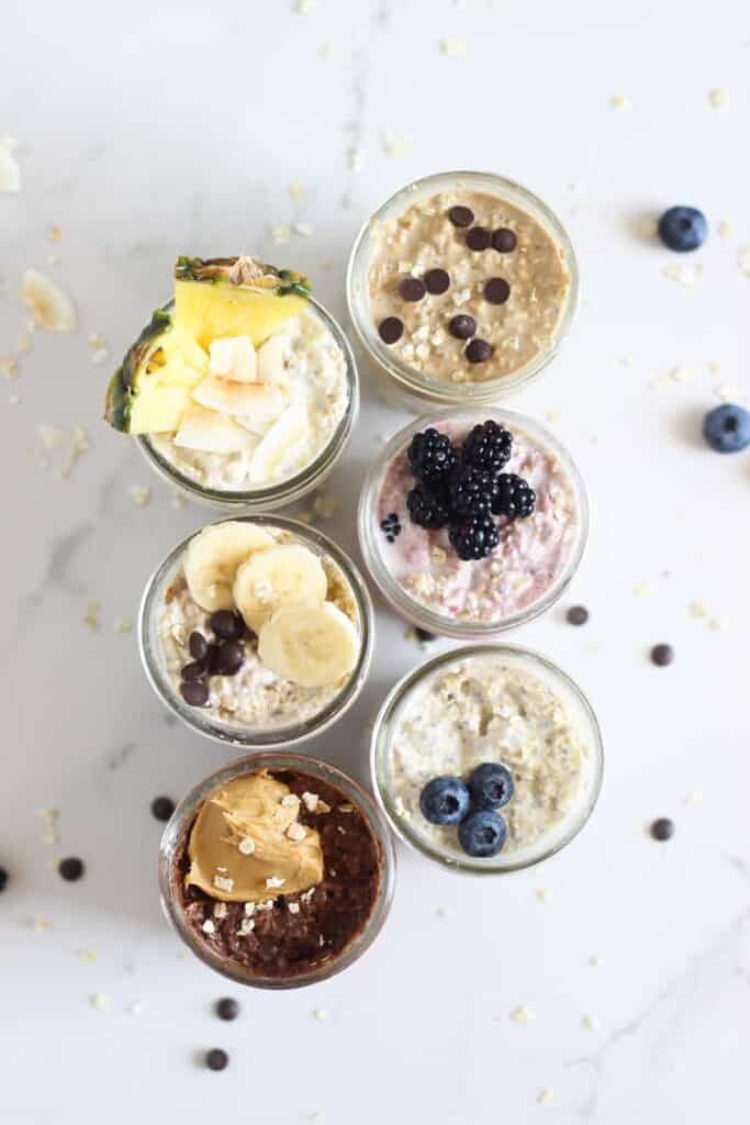 6 jars of overnight oats on a white background