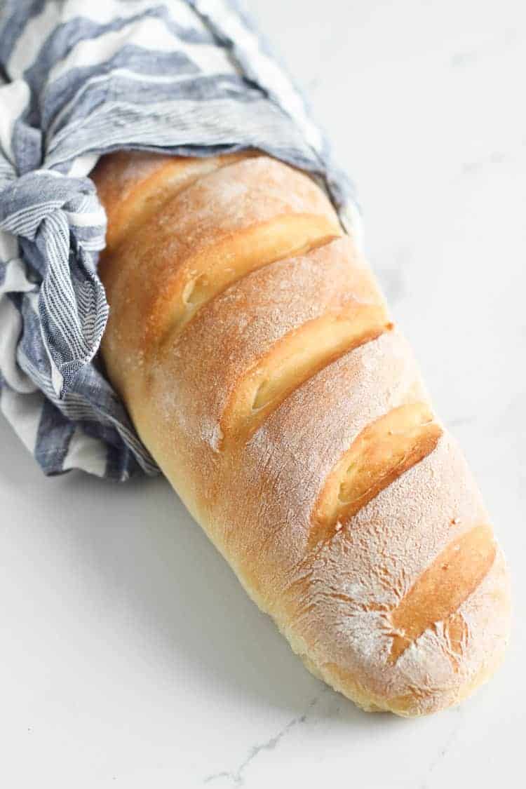 Loaf of French bread wrapped in a bag