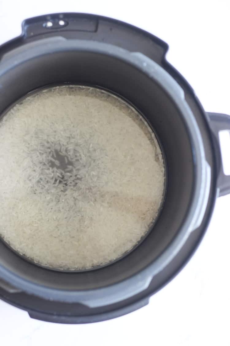 White rice and water in the pot of a multi cooker