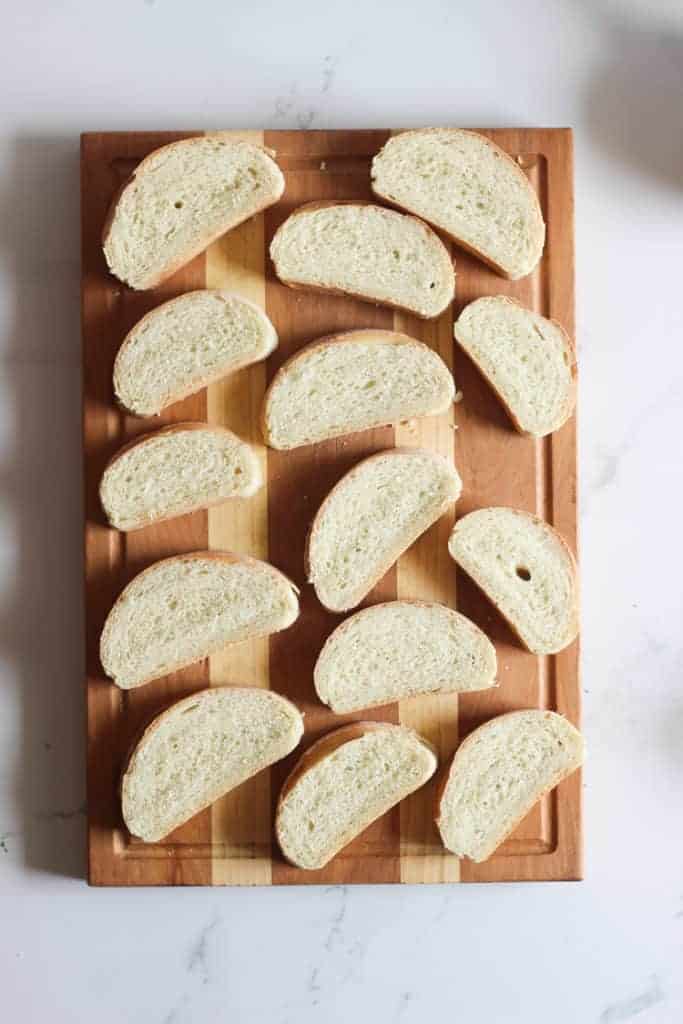 Sliced French Bread on a wooden chopping board