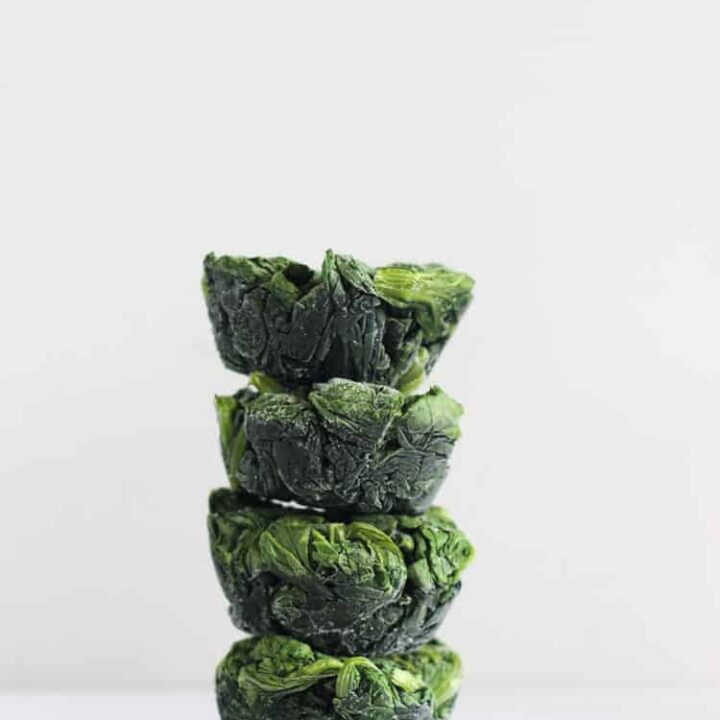 Stack of frozen spinach cups