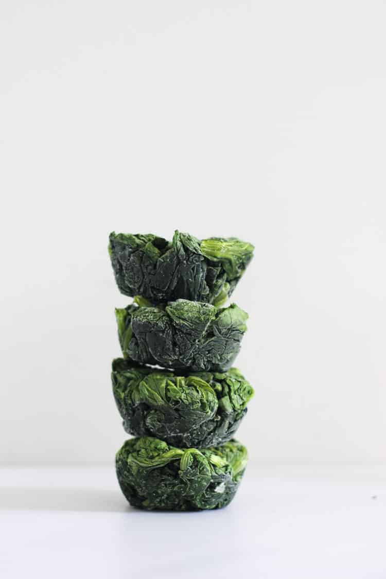 Stack of frozen spinach cups