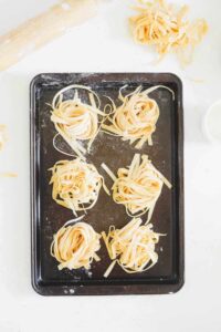 Oven tray with nests of homemade pasta