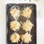 Oven tray with nests of homemade pasta with text overlay