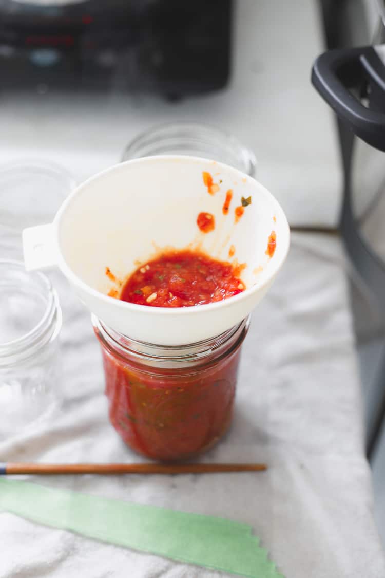 Jar funnel in a jar of tomato salsa