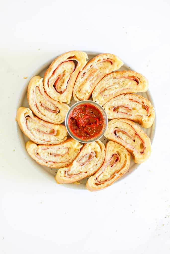 Sliced stromboli on a plate with dipping sauce