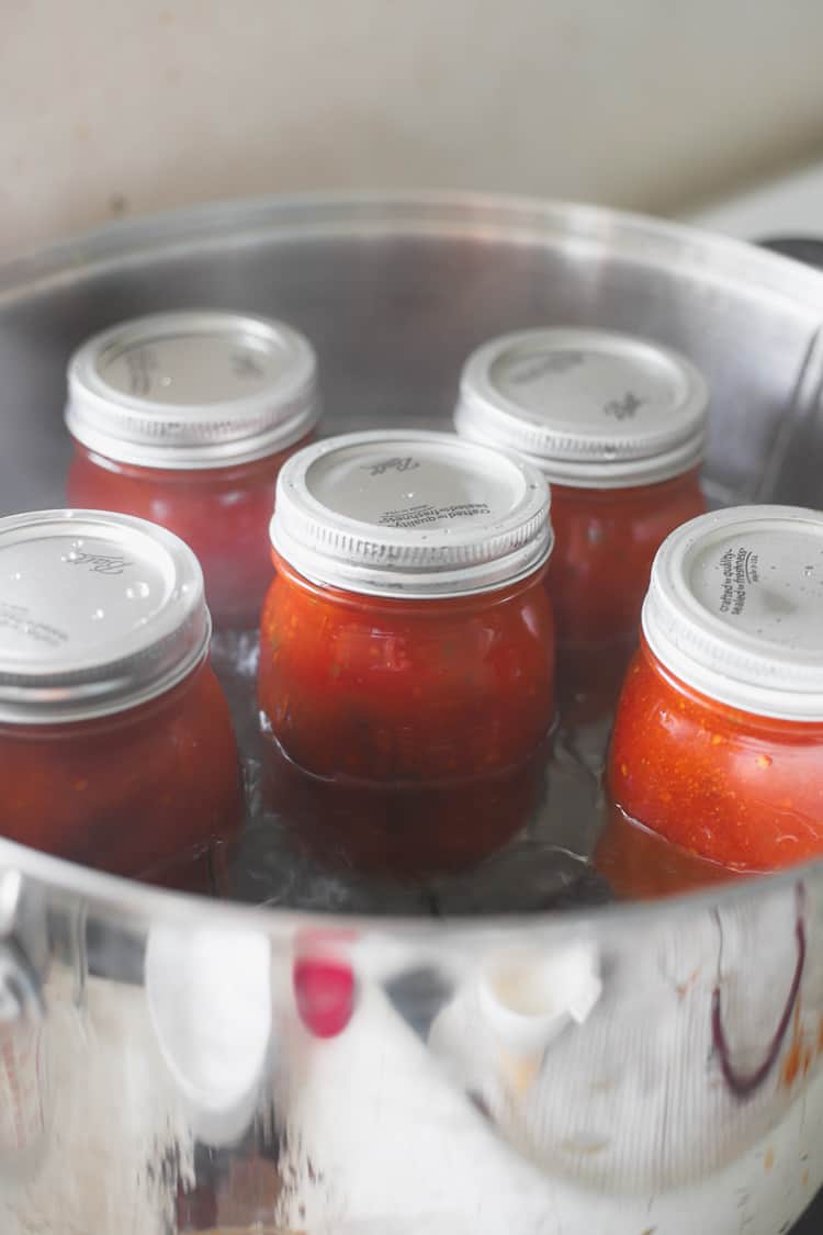 Jars of tomato sauce in a waterbath canner