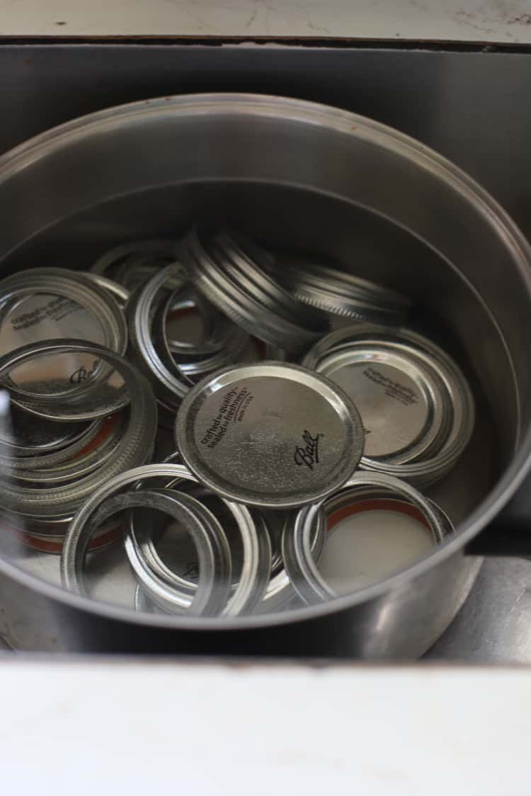 Ball mason lids and bands in a pot of water