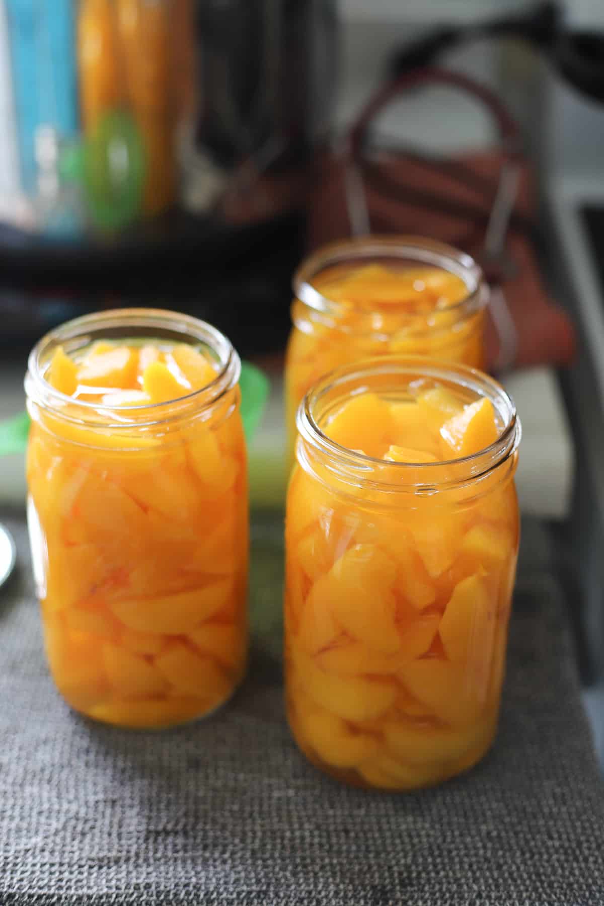 3 quart jars of peaches and sugar syrup without lids