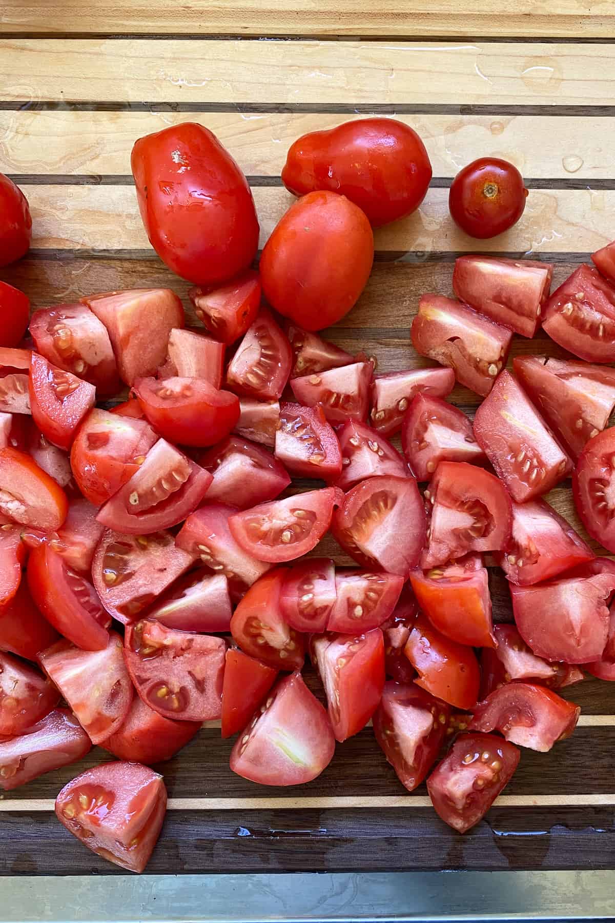 Chopped tomatoes on wooden cutting board