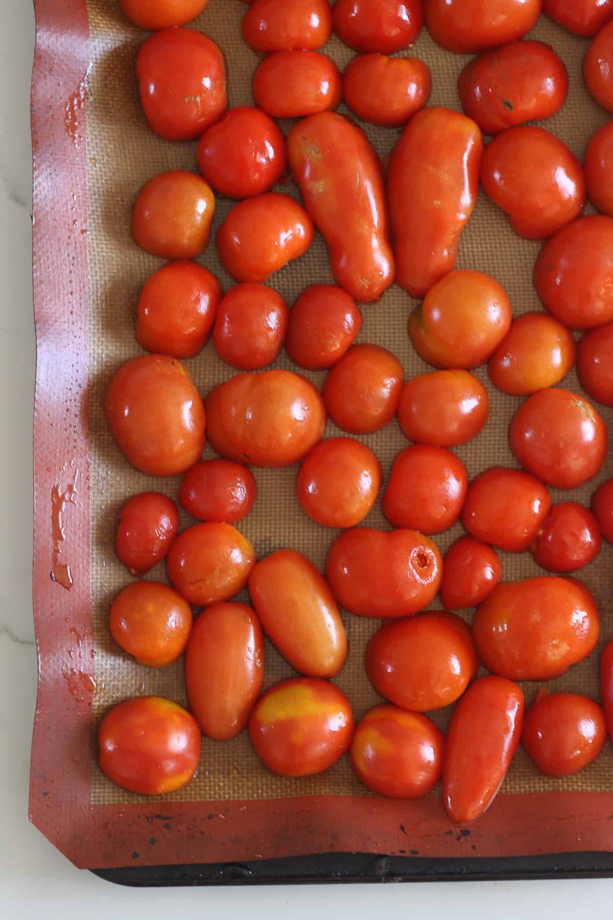 Tomatoes on a lined baking sheet