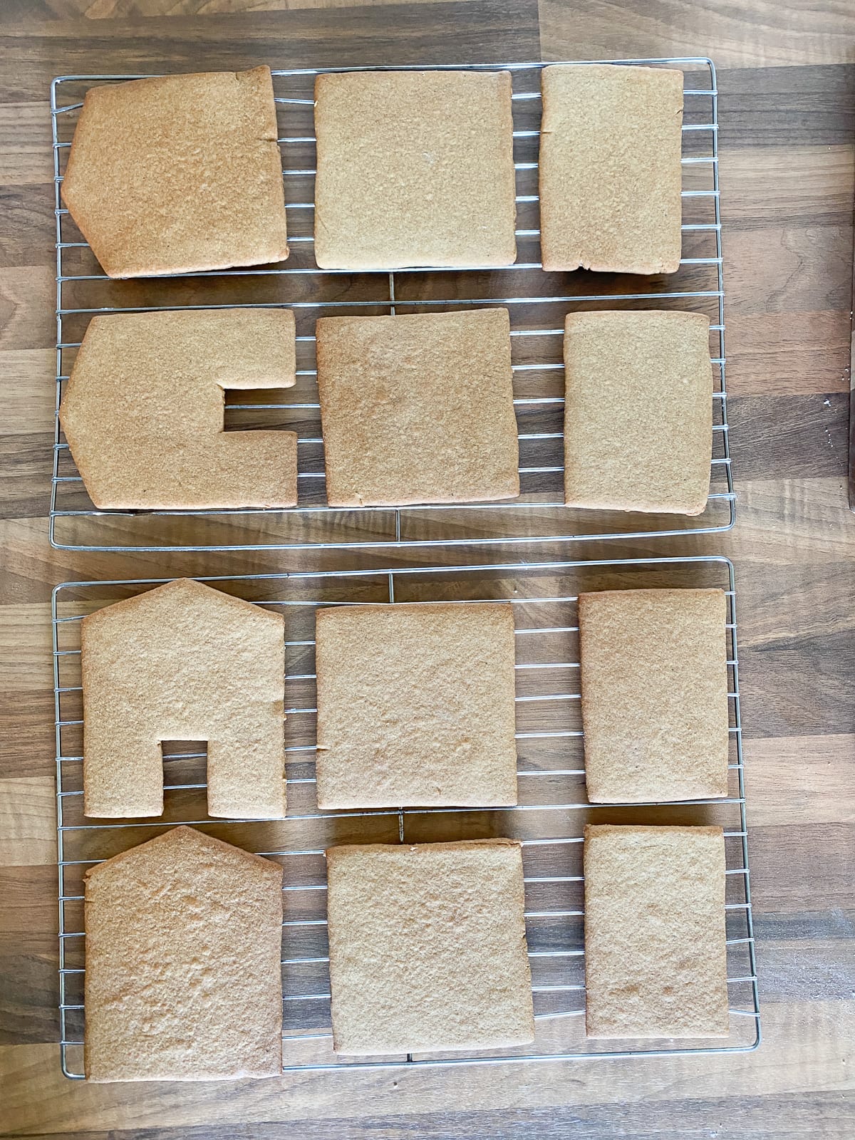 Baked gingerbread house pieces on cooling rack